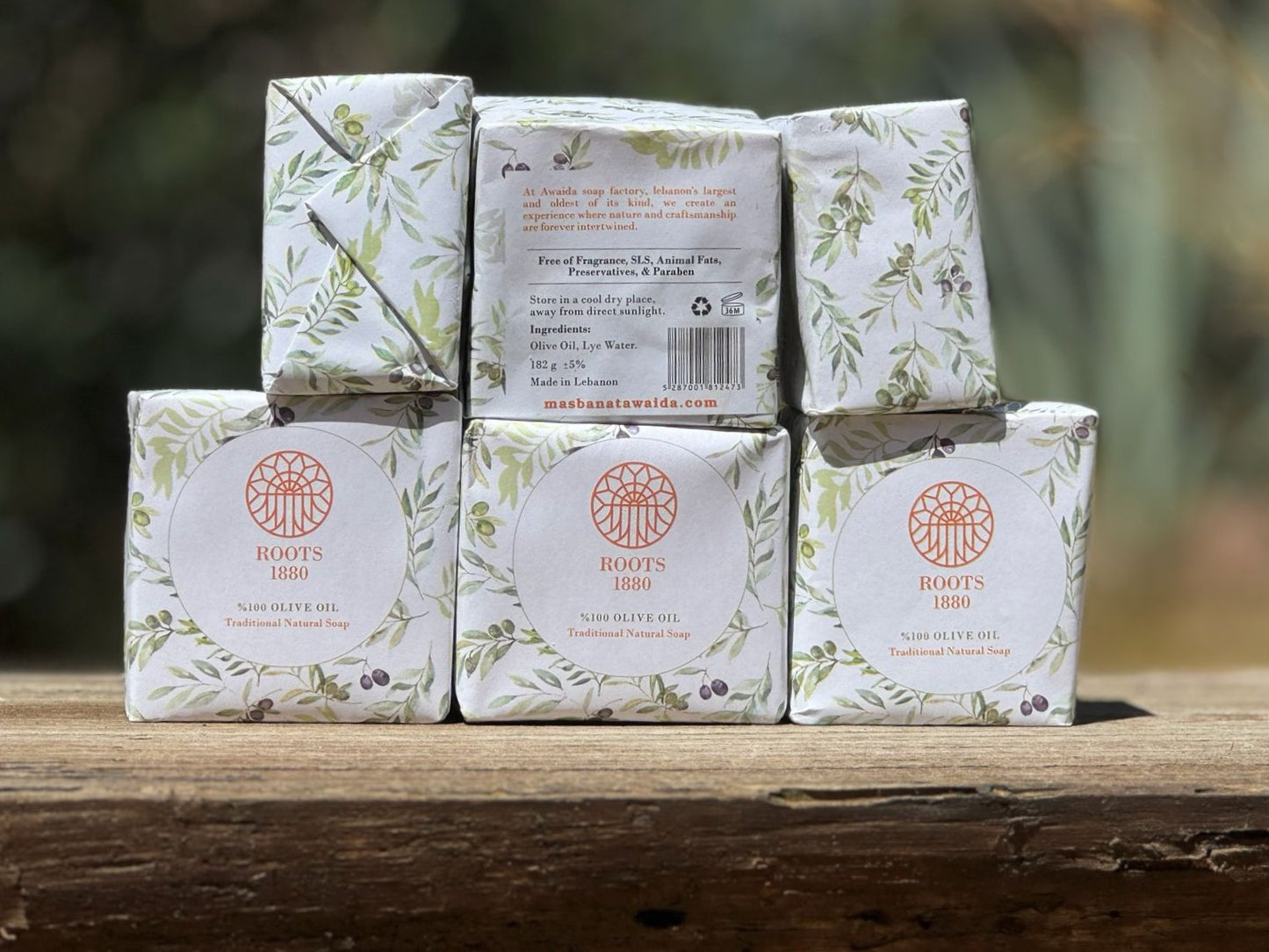 Stack of Roots 1880 soap bars from Awaida with packaging on a wooden surface