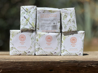 Stack of Roots 1880 soap bars from Awaida with packaging on a wooden surface